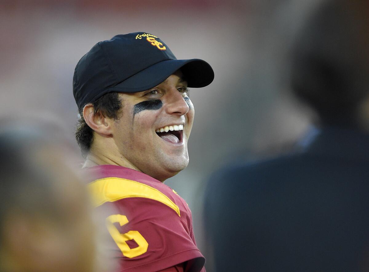 USC quarterback Cody Kessler laughs on the sideline during the second half of the Trojans' game Saturday against Colorado.