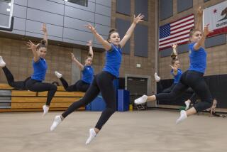 SAN DIEGO, CA - JUNE 7, 2022: Ukrainian National gymnasts, from left, Yelyzaveta Bulavina, 15, Elina Shcherbak, 14, Elina Fomina, 18, Aryna Zemlanko, 17, and Alina Salmanova, 20, perform a jump as they work on a non-competitive performance routine to music about Ukraine's war against Russia, by Ukrainian musicians, during practice at the Hourglass Gymnasium in San Diego on Tuesday, June 7, 2022. (Hayne Palmour IV / For The San Diego Union-Tribune)