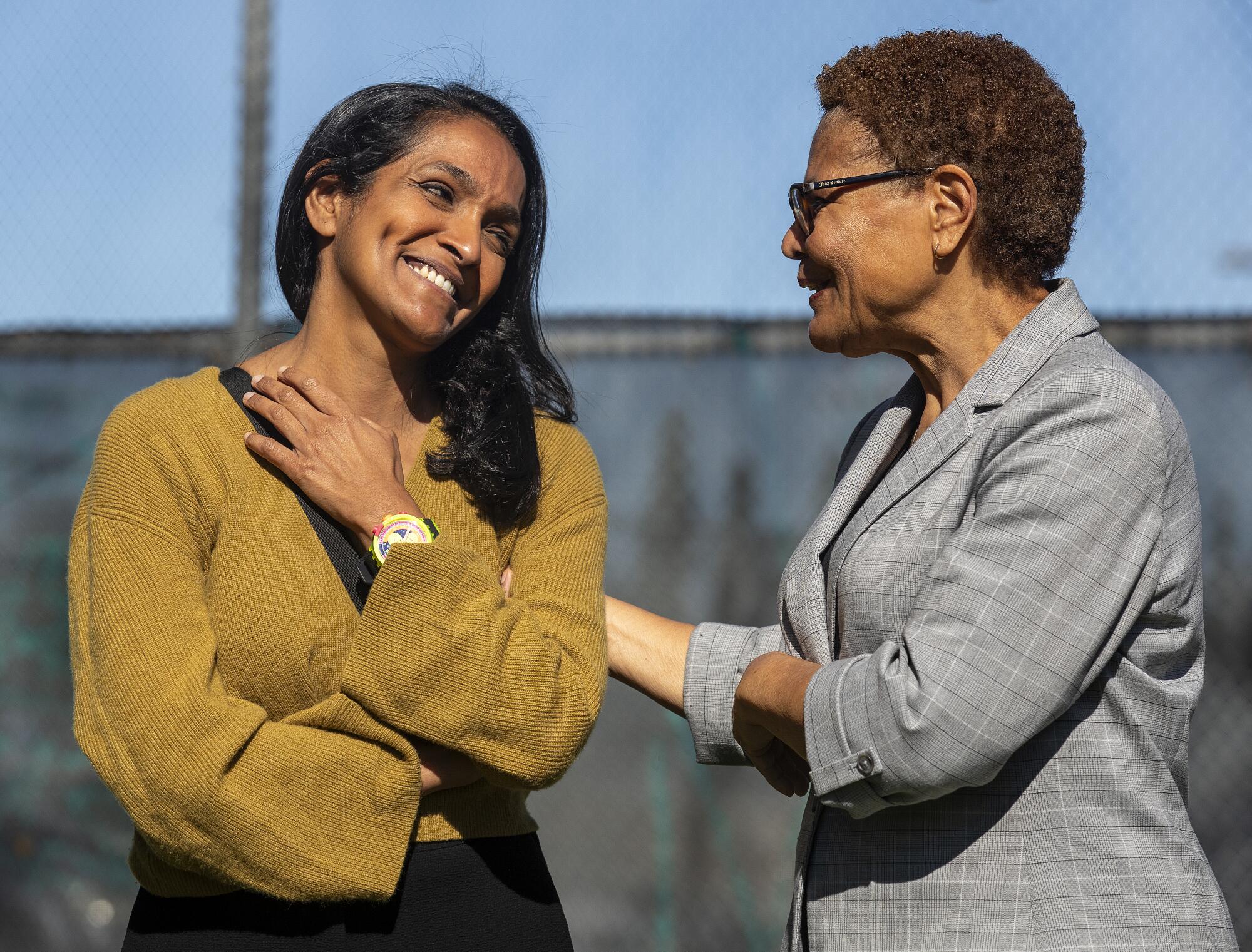 Los Angeles City Councilmember Nithya Raman, left, talks with Mayor Karen Bass at one of her campaign events in Sherman Oaks.