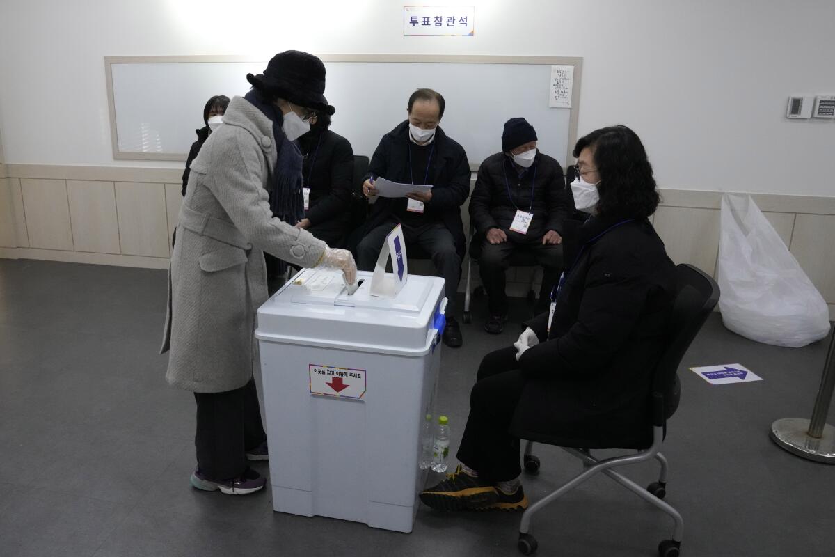 A voter casts a ballot in the presidential election at a local polling station in Seoul, South Korea.