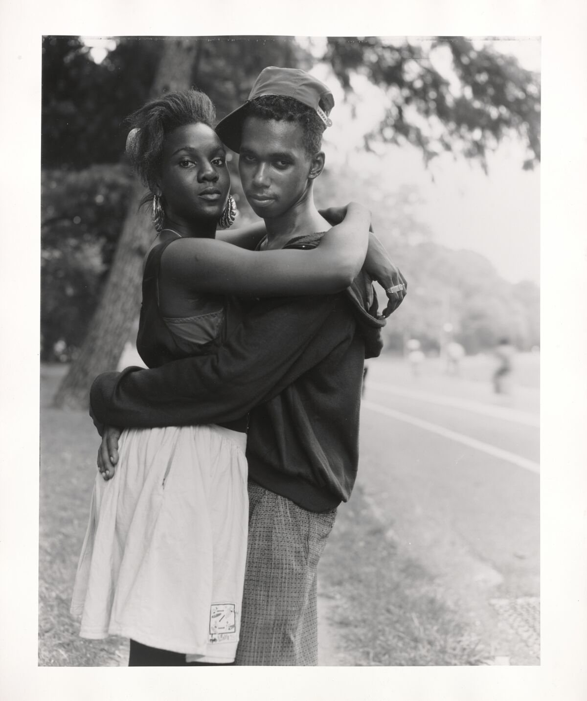 A couple hugging in the park.