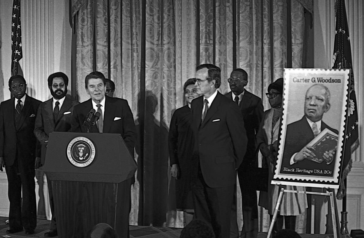 President Reagan speaking at a lectern beside a large illustration of a postage stamp