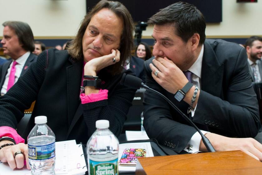 Mandatory Credit: Photo by MICHAEL REYNOLDS/EPA-EFE/REX (10152216e) CEO of T-Mobile John Legere (L) and Executive Chairman of Spring Marcelo Claure (R) speak with one another before testifiying at a House Judiciary subcommittee hearing on 'The State of Competition in the Wireless Market: Examining the Impact of the Proposed Merger of T-Mobile and Sprint on Consumers, Workers, and the Internet', on Capitol Hill in Washington, DC, USA, 12 March 2019. Critics of the proposed multi-billion US dollar merger between T-Mobile and Sprint say it would negatively impact the variety and number of jobs in the market. House Judiciary subcommittee hearing on proposed merger between T-Mobile and Sprint, Washington, USA - 12 Mar 2019 ** Usable by LA, CT and MoD ONLY **