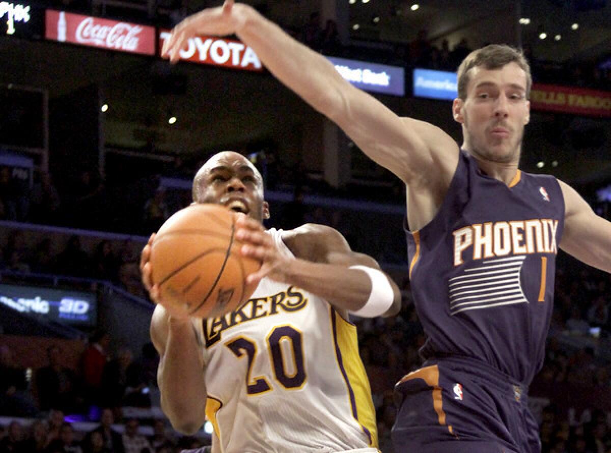Lakers guard Jodie Meeks drives to the basket against Suns guard Goran Dragic in the first half Sunday at Staples Center.