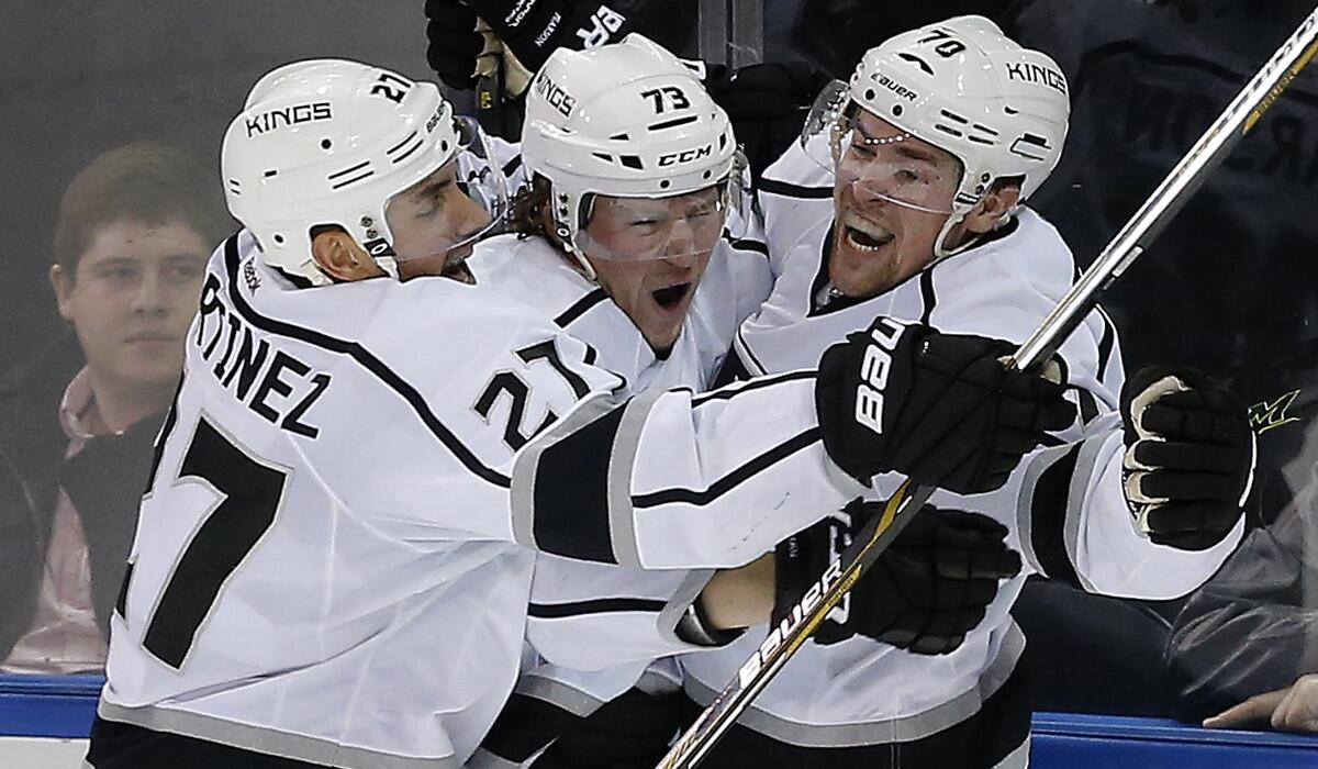 Kings left wing Tanner Pearson (70) celebrates with center Tyler Toffoli (73) and defenseman Alec Martinez (27) after scoring against the New York Rangers in overtime on Feb. 12, 2016.