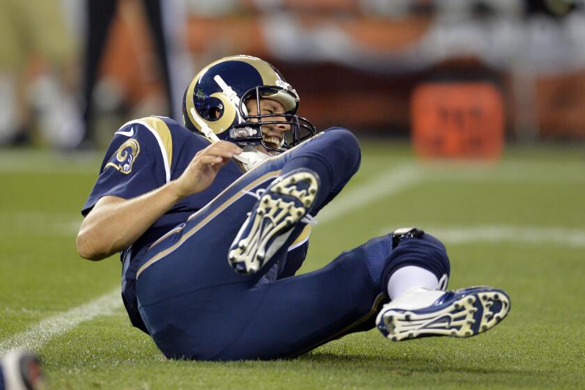 St. Louis quarterback Sam Bradford grimaces after being hit by Cleveland defensive lineman Armonty Bryant in the first quarter of Saturday's preseason game.