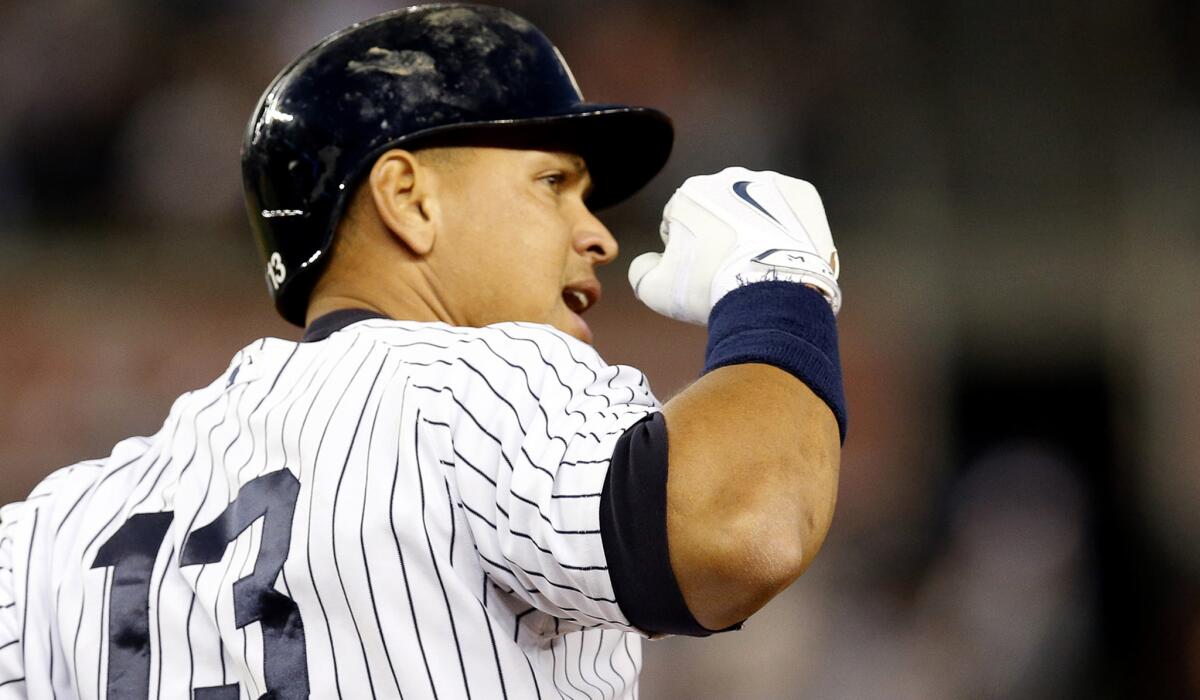 Yankees designated hitter Alex Rodriguez pumps his fist as he runs the bases after hitting his 661st home run to move ahead of Willie May into fourth on the all-time list.