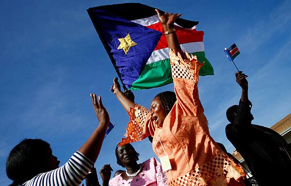 Sudanese refugees wave the flag of southern Sudan after voting for secession at a polling station at St. James Roman Catholic Parish in Glendale, Ariz. Mistrust in the process ran high at first.