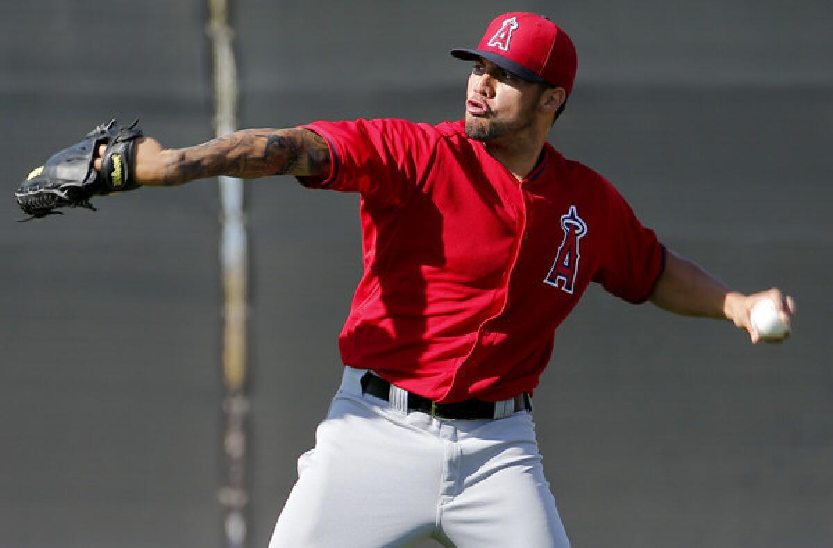 Angels pitcher Hector Santiago warms up during a spring training workout on Saturday.