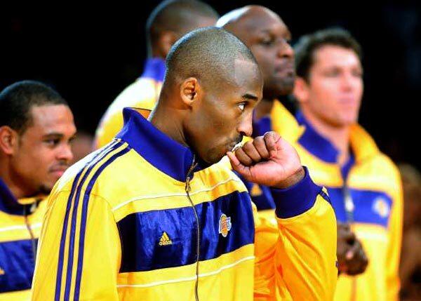 Lakers guard Kobe Bryant kisses his championship ring as he waits for the 2010 championship banner to be unfurled in the Staples Center rafters on Tuesday night.