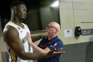 New Orleans Pelicans power forward Zion Williamson (1) jokes with David Griffin, executive vice president of basketball operations, during the NBA Pelicans basketball media day in New Orleans, Monday, Sept. 26, 2022. (AP Photo/Matthew Hinton)