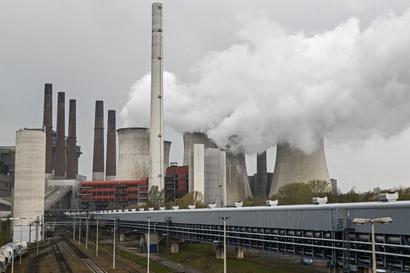A coal-fired RWE power plant steams on a sunny day in Neurath, Germany, Thursday, April 29, 2021. Germany's top court ruled Thursday that the country's government has to set clear goals for reducing greenhouse gas emissions after 2030, arguing that current legislation doesn't go far enough in ensuring that climate change is limited to acceptable levels. (AP Photo/Martin Meissner)