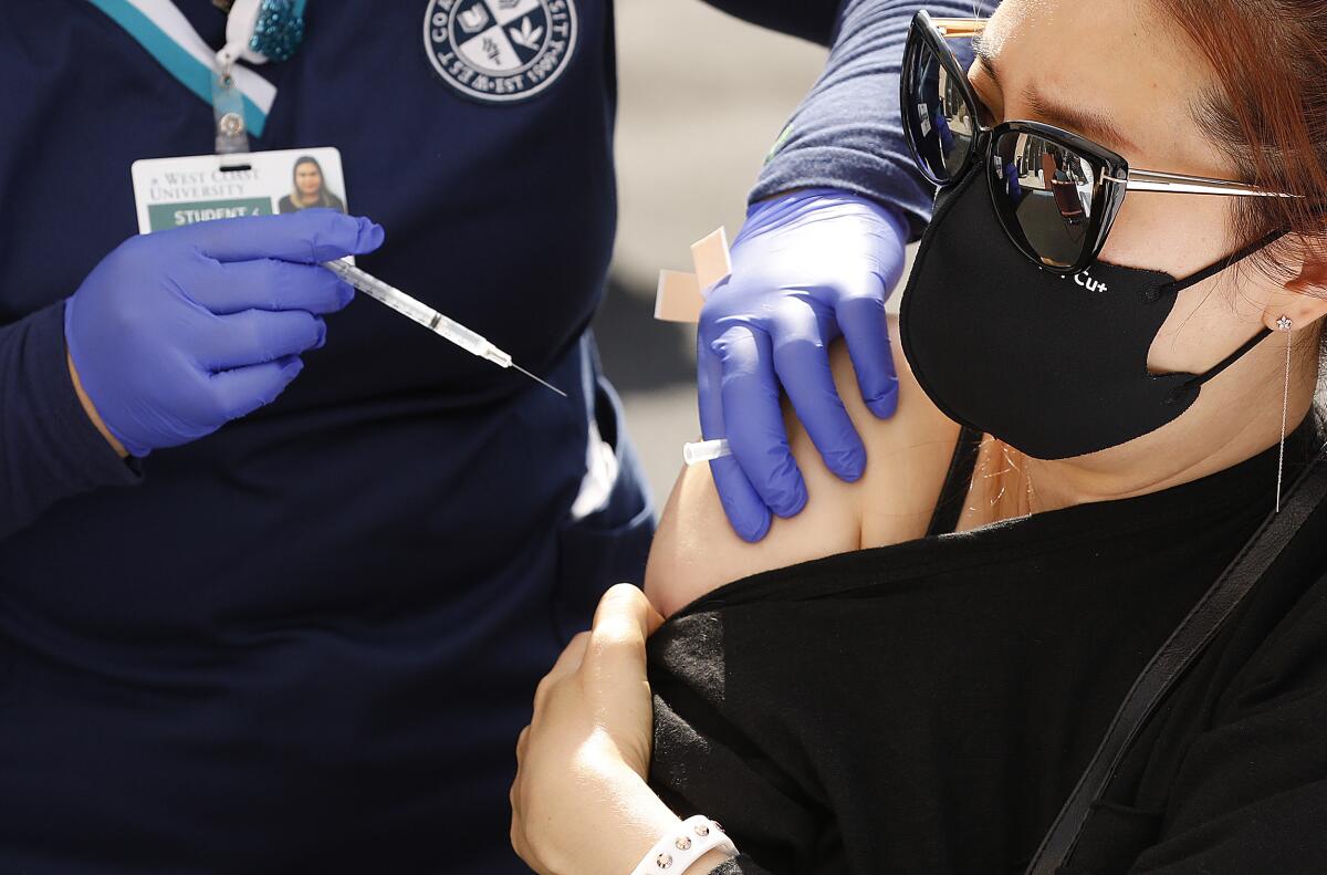 A woman receives a COVID-19 vaccination.