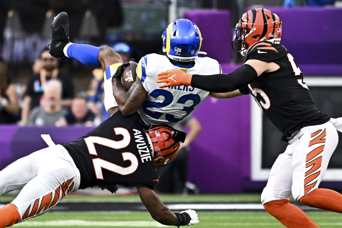 Bengals cornerback Chidobe Awuzie (22) tackles Rams running back Cam Akers on a sweep.