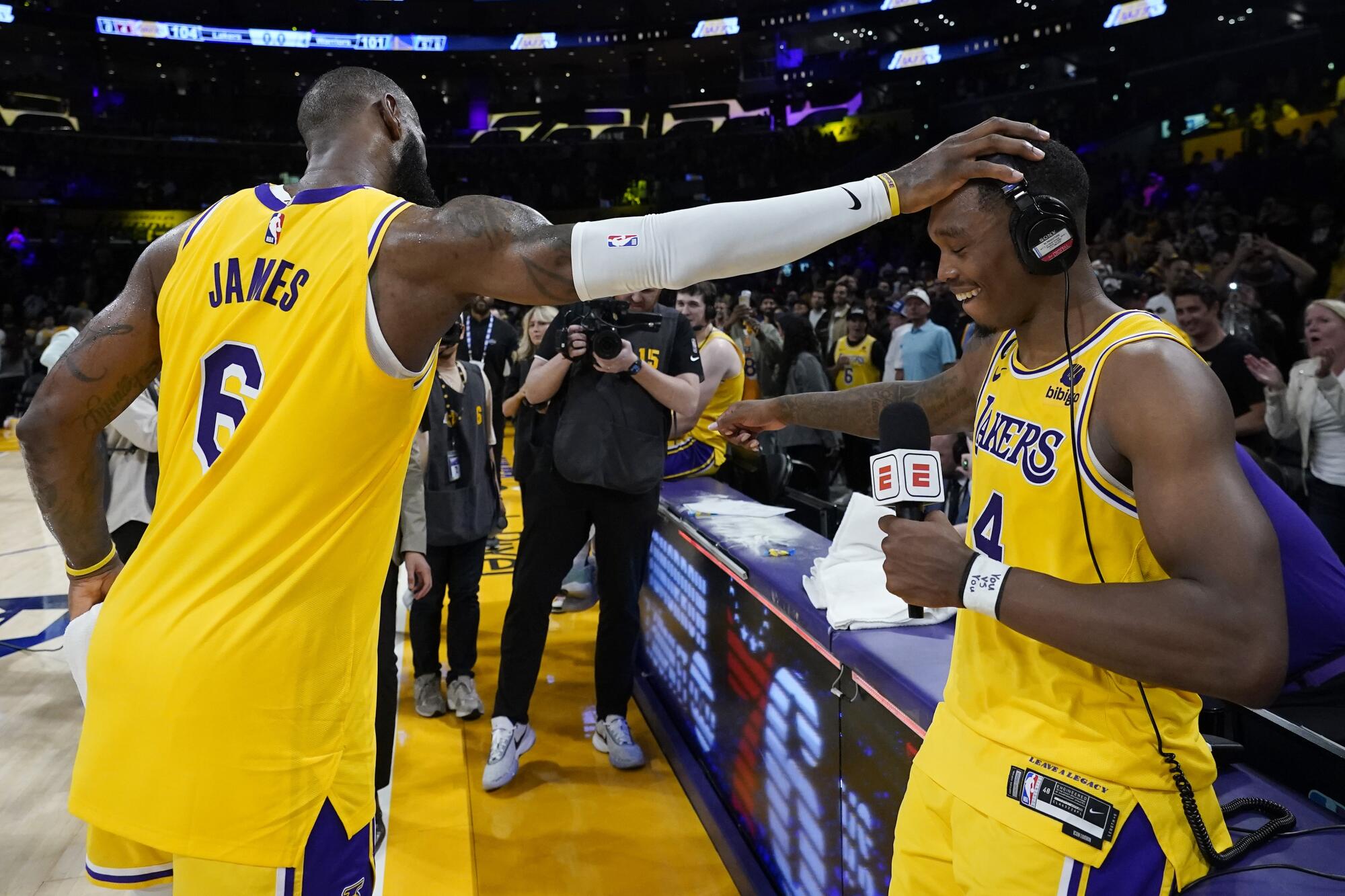 Los Angeles Lakers' LeBron James, left, congratulates Lonnie Walker IV.
