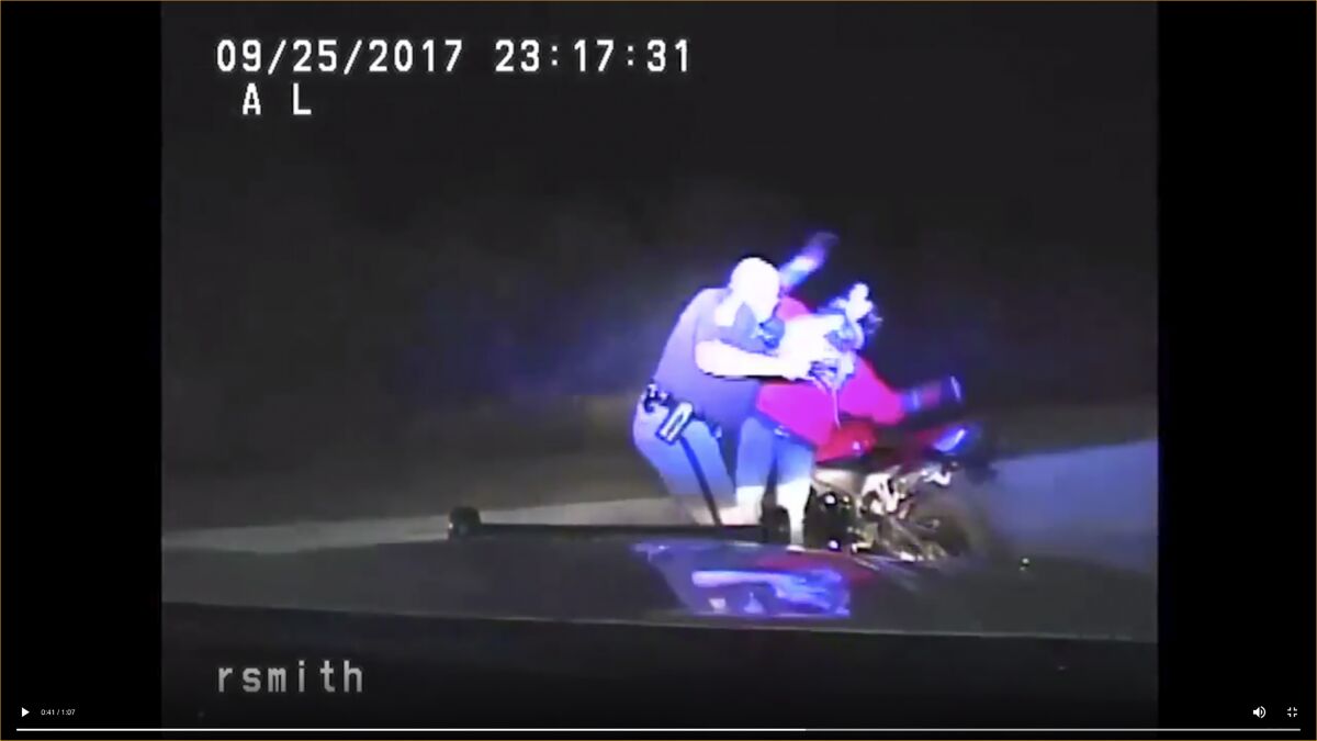 FILE - This 2017 image from the Iowa State Patrol video provided by the Cedar County Attorney's Office in Cedar County, Iowa, shows former Iowa State Patrol trooper Robert Smith in an altercation with Bryce Yakish by Yakish's motorcycle during a traffic stop near Tipton, Iowa. Smith, a former Iowa State Patrol officer with a history of excessive force allegations, has been indicted on a federal charge over the 2017 traffic stop that was captured on video and during which Yakish was injured. (Cedar County Attorneys Office via AP, File)