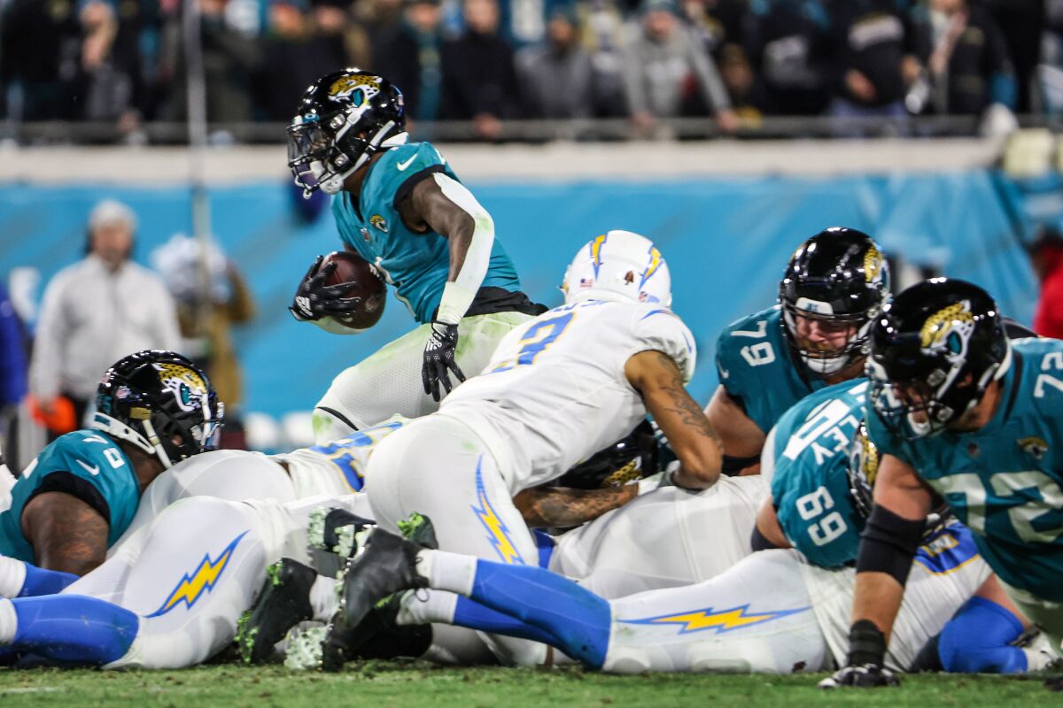 Jaguars running back Travis Etienne Jr. (1) sprints past the Chargers defense on fourth down to set up the deciding score.