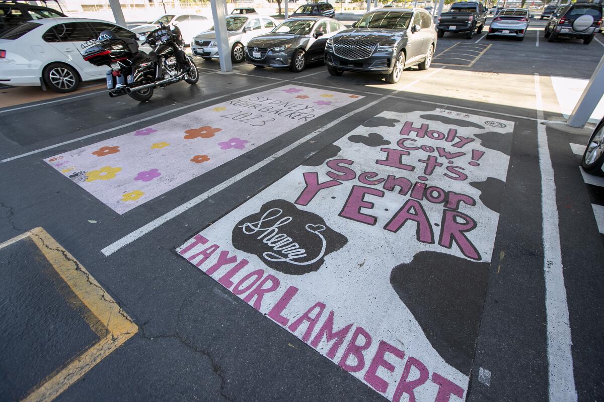 Customized parking spaces adorn the lot in front of Marina High School in Huntington Beach.