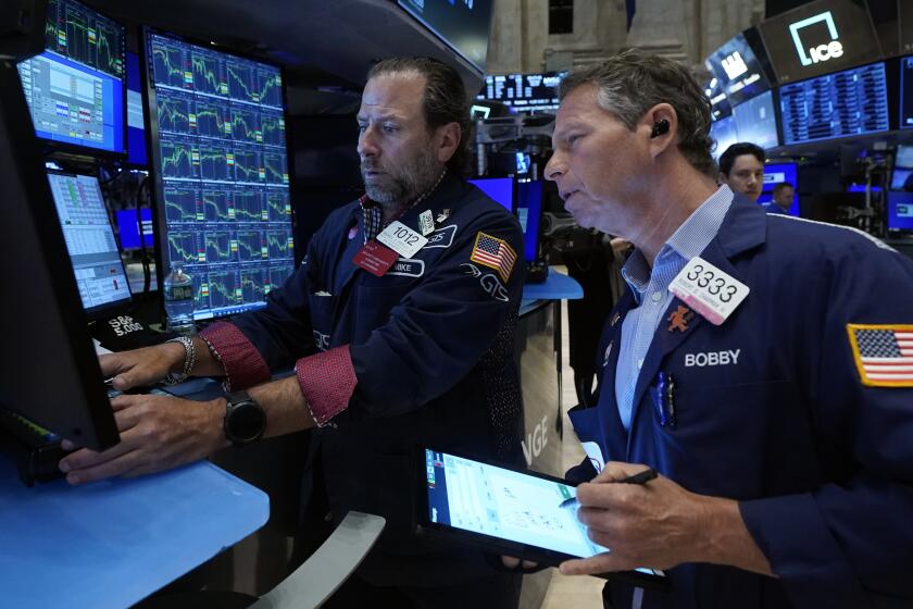 FILE - Specialist Michael Pistillo, left, and trader Robert Charmak work on the floor of the New York Stock Exchange, May 30, 2024. World shares began June mostly higher after a report showing that inflation in the U.S. is not worsening drove a rally on Wall Street. (AP Photo/Richard Drew, File)