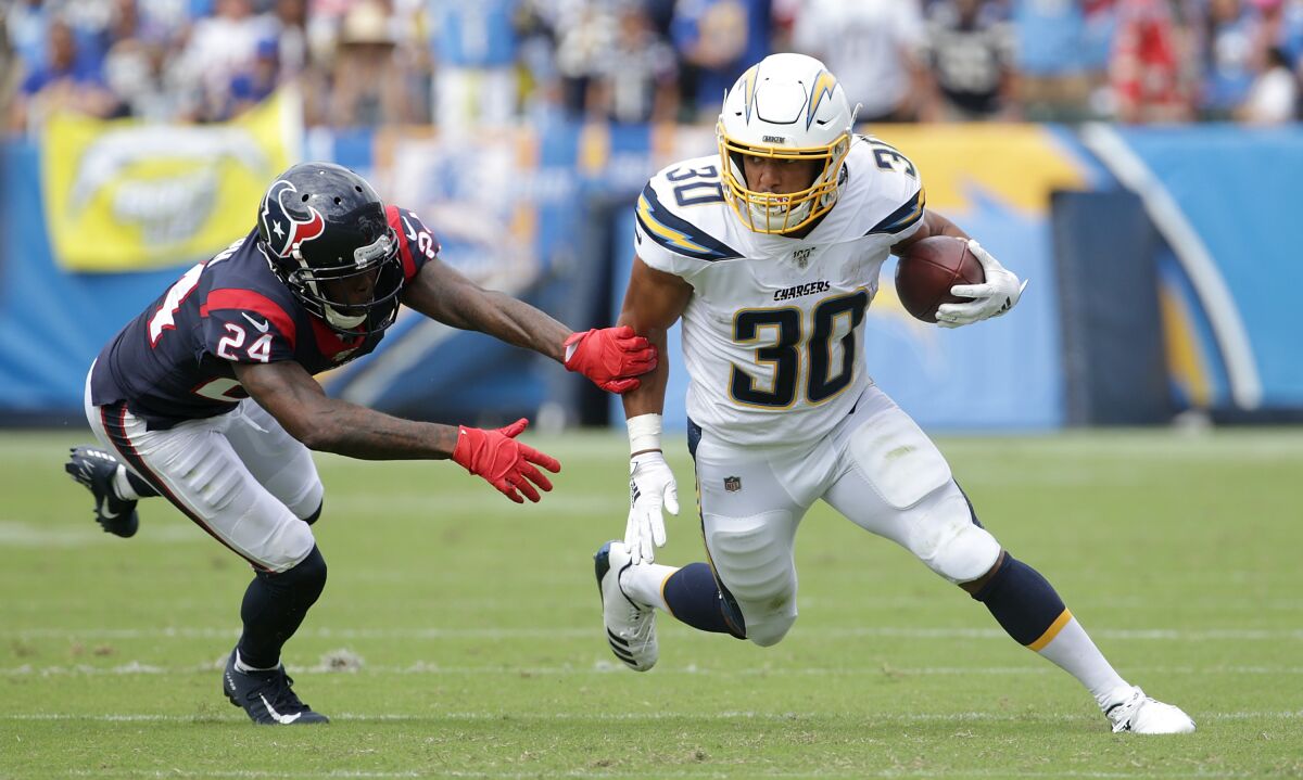 Chargers running back Austin Ekeler carries the ball against the Texans.