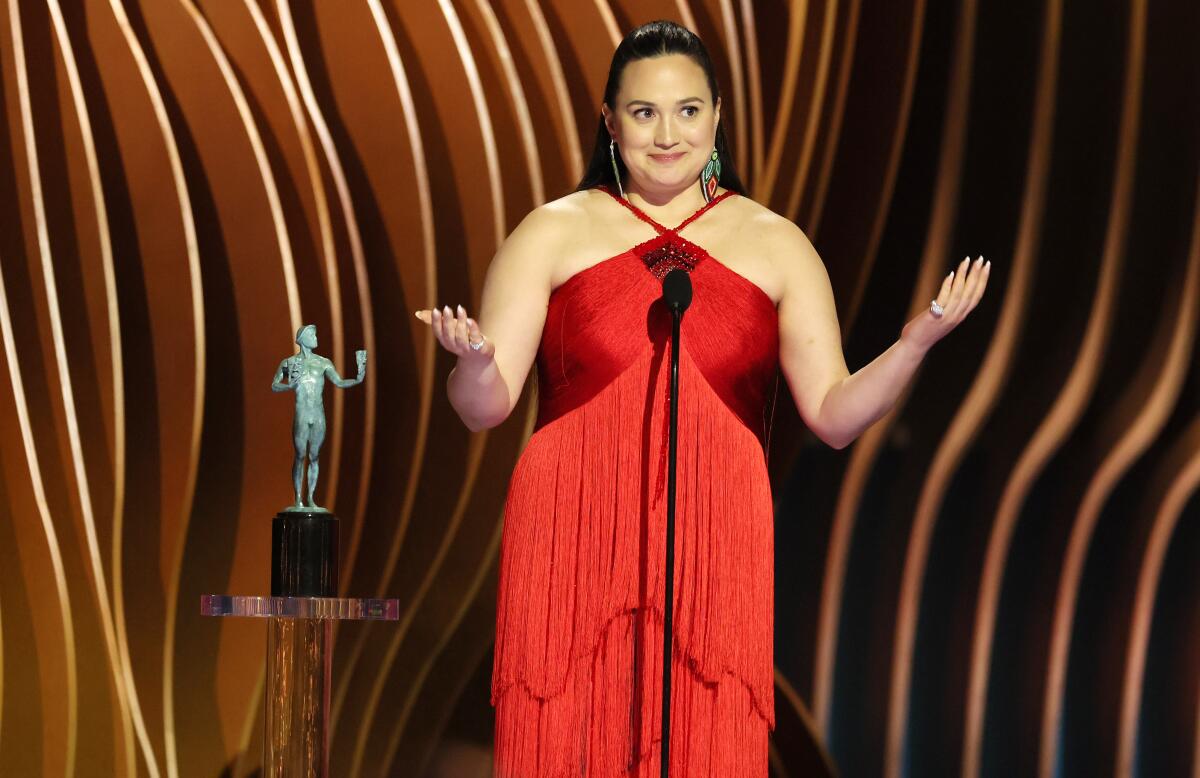 Lily Gladstone gestures with both hands during her Screen Actors Guild lead actress acceptance speech.