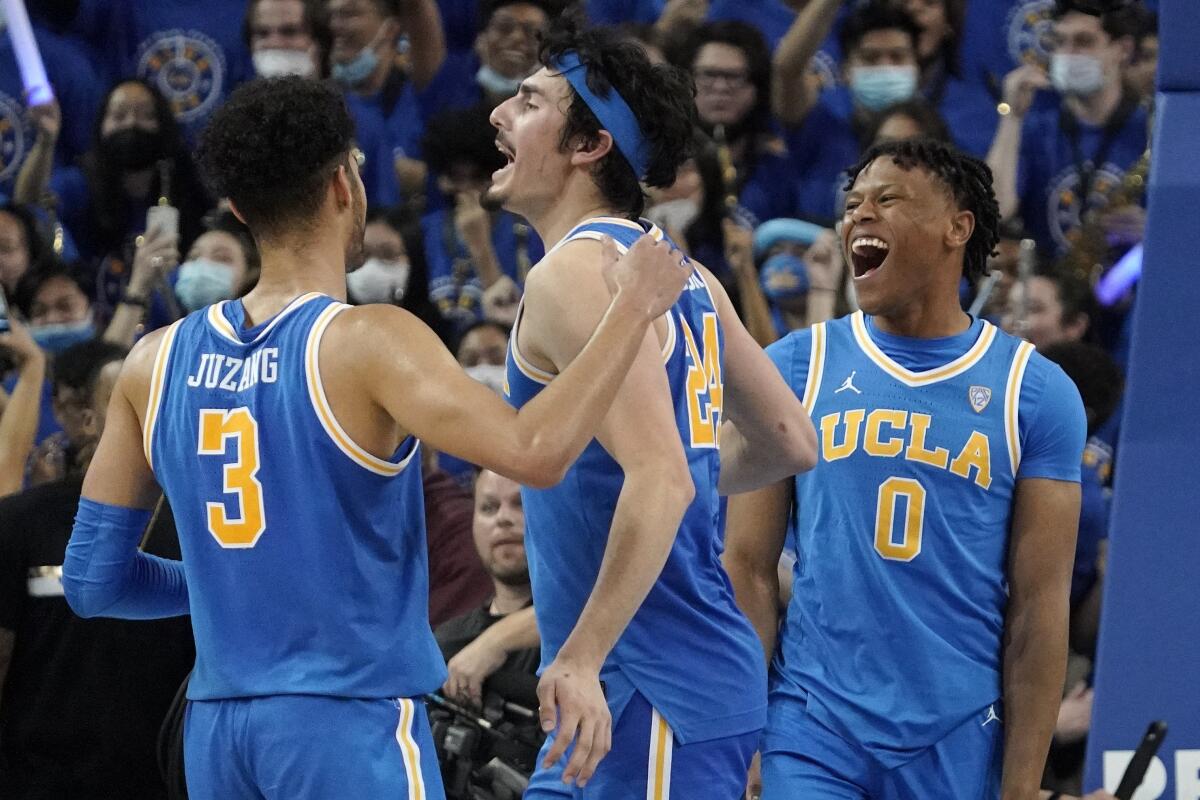 UCLA's Jaime Jaquez Jr., center, celebrates with Johnny Juzang, left, and Jaylen Clark.