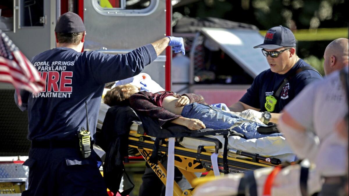 Medical personnel tend to a victim following last year’s shooting at Marjory Stoneman Douglas High School in Parkland, Fla.