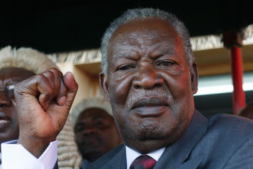 Zambian President Michael Sata waves after taking the oath of office in Lusaka on Sept. 23, 2011.
