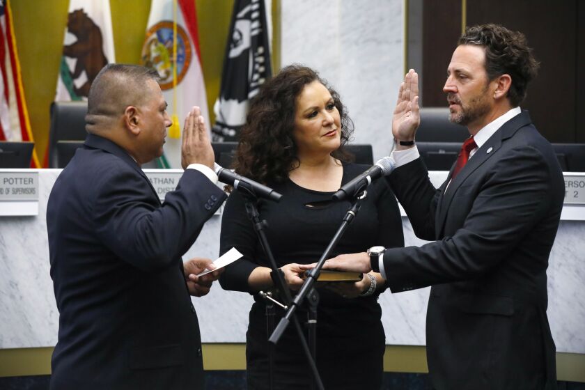 1238471-sd-me-county-swearing-in_NL January 9, 2023 San Diego, CA Supervisor Nathan Fletcher (right) is sworn in by Patrick Casao, Jr., as his wife, Lorena Gonzalez Fletcher hold the bible. Today was the formal swearing-in ceremony for county officials including Supervisors Nathan Fletcher and Jim Desmond, Sheriff Kelly Martinez, District Attorney Summer Stephan, Assessor/Recorder/County Clerk Jordan Marks and Treasurer/Tax Collector Dan McAllister. The event was held at the County Administration Building. © 2022 Nancee Lewis / Nancee Lewis Photography