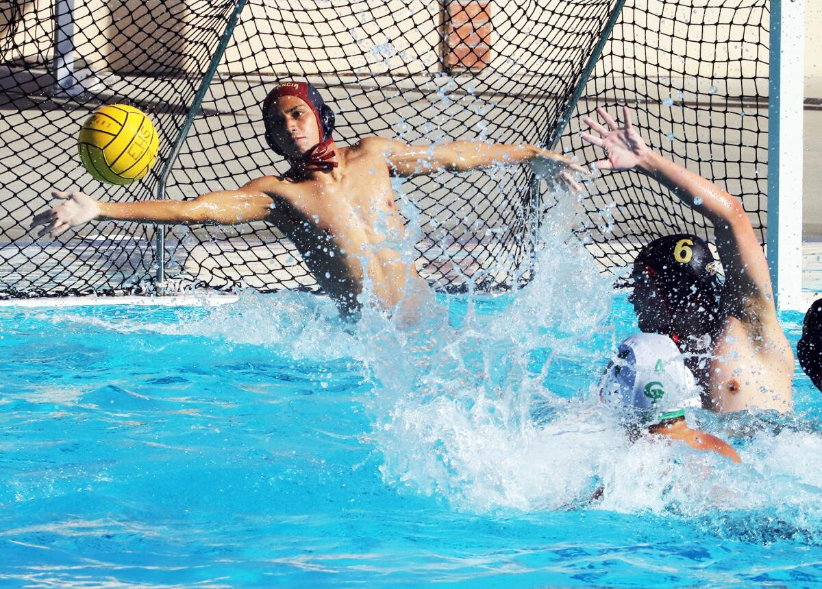 Estancia goalie Alex Garcia (1) tries to block the shot of Costa Mesa's Wes Brazda during Wednesday's match.