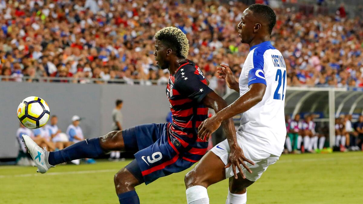 Playing for the United States, the Galaxy's Gyasi Zardes keeps the ball away from Martinique's Sebastien Cretinoir during a World Cup qualifier earlier this year.
