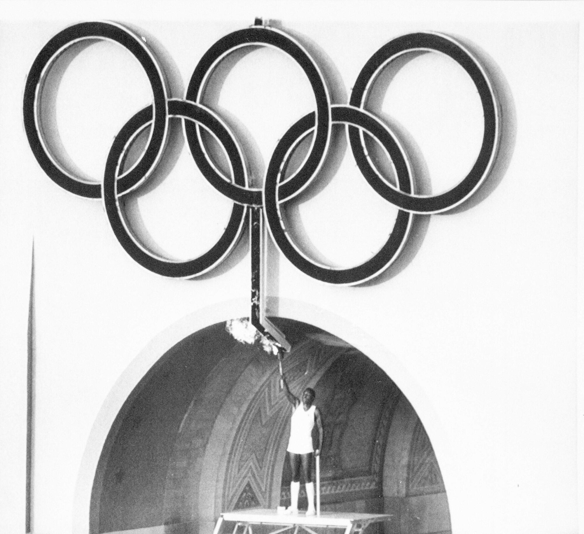 Rafer Johnson lights the Olympic torch during opening ceremonies in 1984.