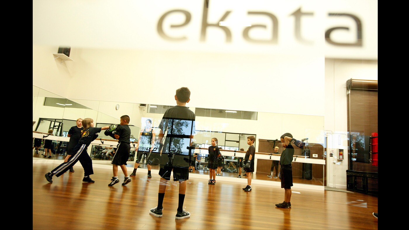 Youngsters participate in savate, a French-style kickboxing class, at the Ekata fitness center in Valencia.