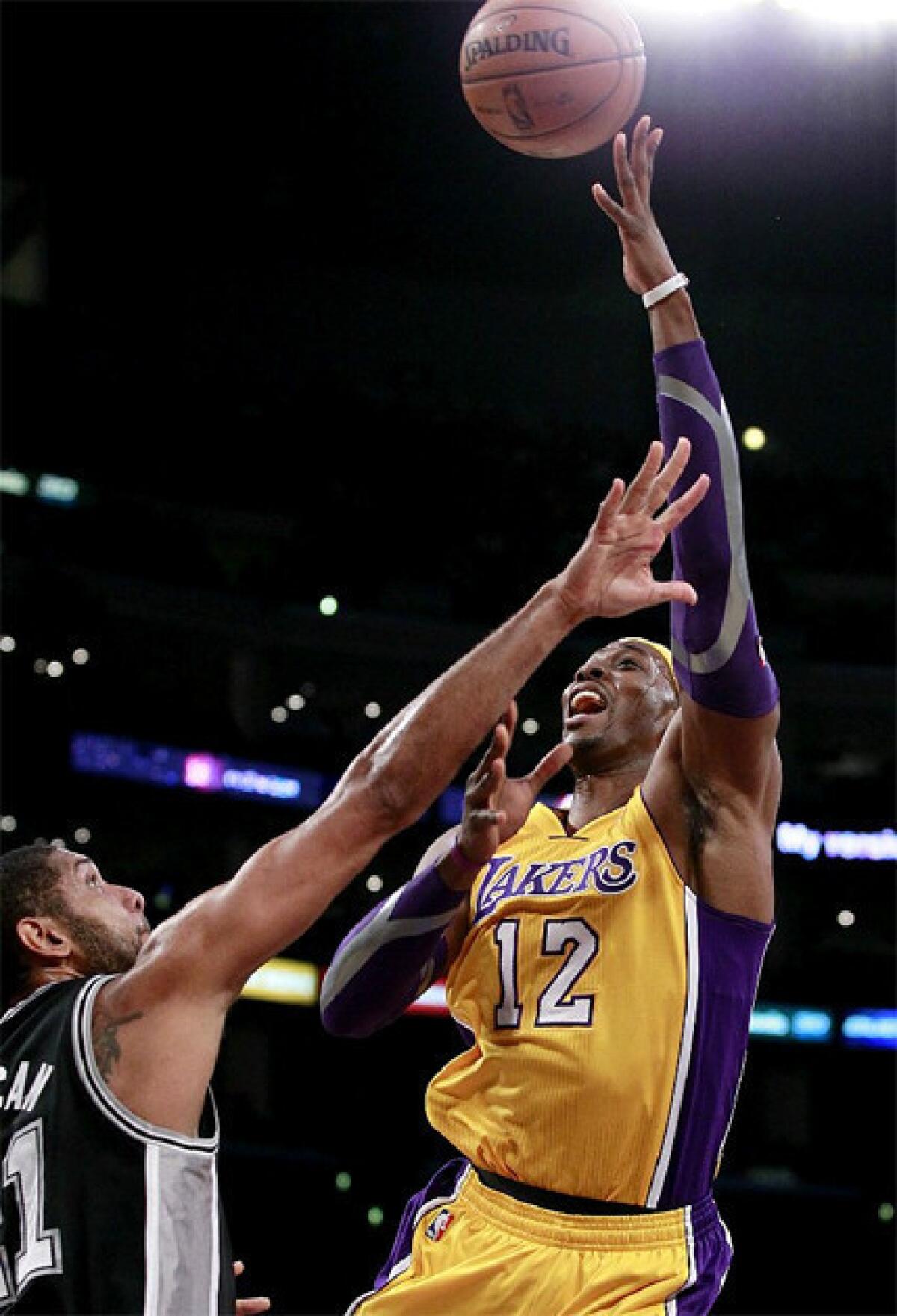 Dwight Howard shoots over Tim Duncan in the Lakers match-up against the Spurs.