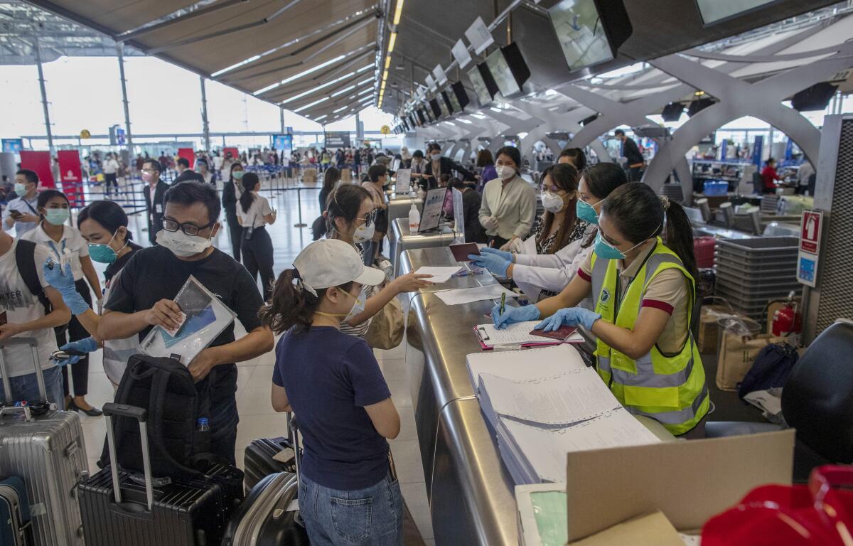 Tourists from Wuhan, China, undergo health checks before boarding a charter flight home from Thailand at Bangkok's Suvarnabhumi Airport on Jan. 31, 2020.