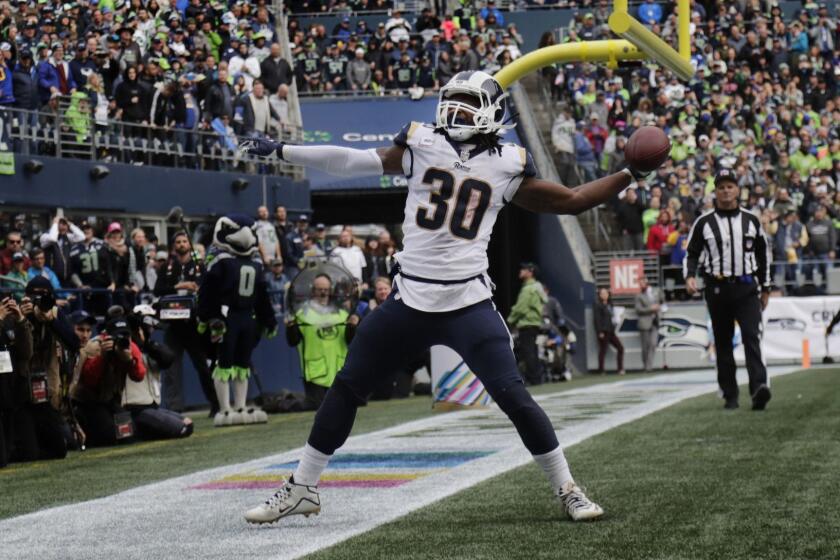 SEATTLE, WA - OCTOBER 7, 2018: Los Angeles Rams running back Todd Gurley (30) gets ready to spike the ball after scoring one of his three rushing touchdowns against the Seattle Seahawks in the 4th quarter at CenturyLink Field on October 7, 2018 in Seattle, Washington.(Gina Ferazzi/Los AngelesTimes)