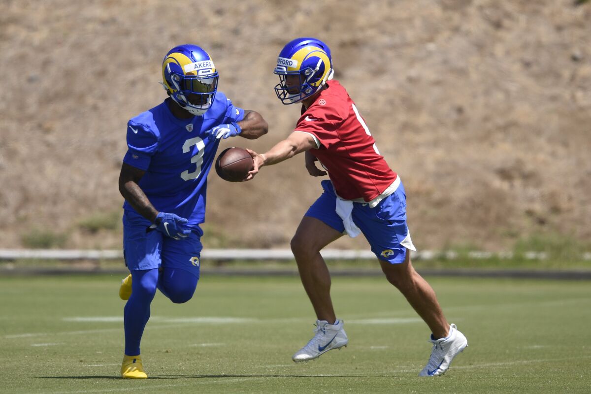Rams quarterback Matthew Stafford hands off the football to Cam Akers during a drill in Thousand Oaks. 