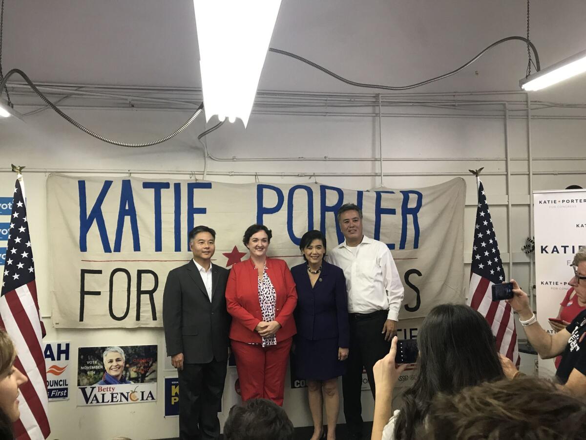 U.S. Reps. Ted Lieu, left, Mark Takano and Judy Chu, second from right, pose with Katie Porter after rallying volunteers.