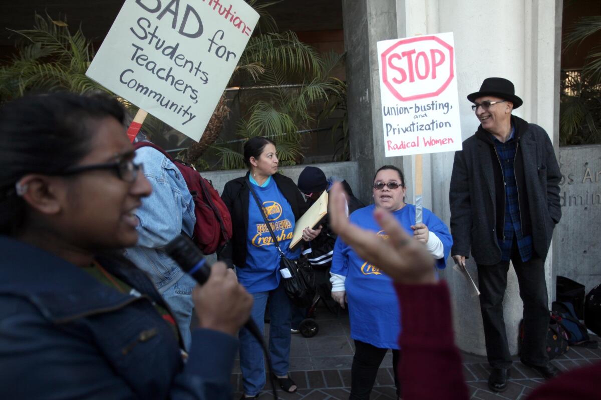 Parents, students and teachers rally in front of L.A. Unified headquarters to protest a proposal to restructure low-performing Crenshaw High School. Shruti Purkayastha, left, leads a small group of protesters outside the district headquarters.