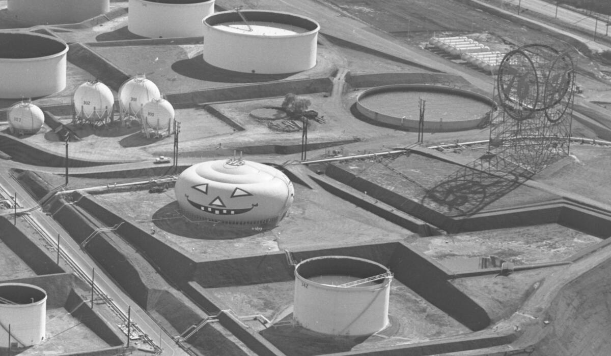 Aerial view of an oil tank painted to look like a jack-o-lantern.