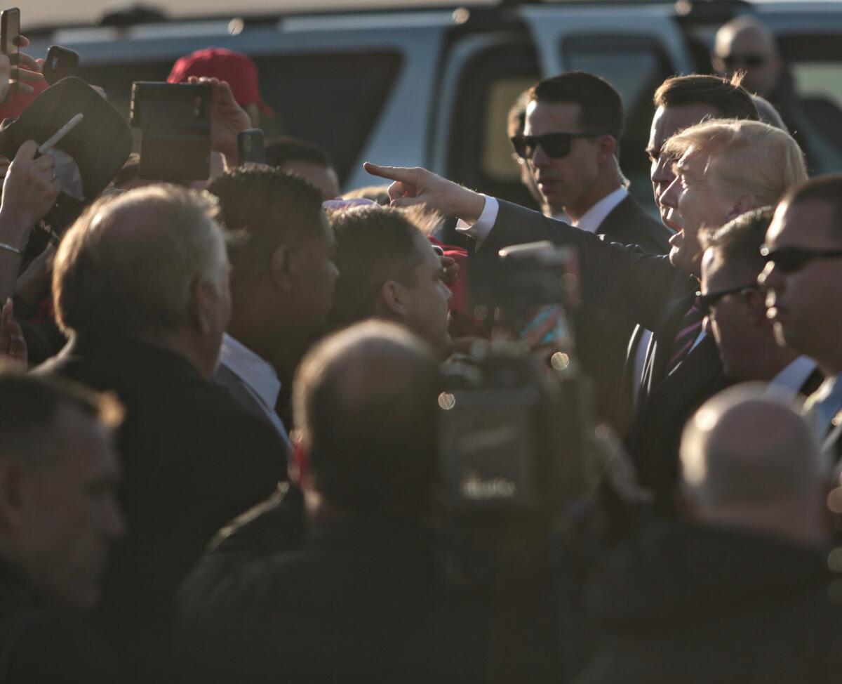 President Trump greets supporters on the tarmac at LAX