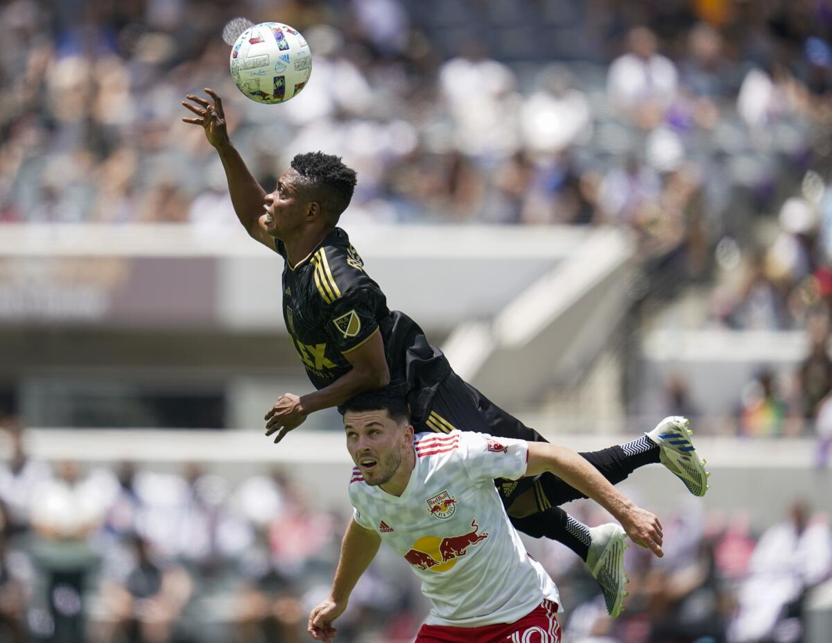 LAFC's Latif Blessing jumps over Lewis Morgan.