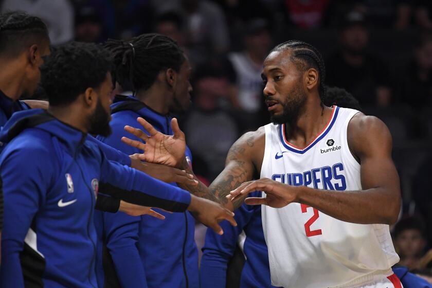 LOS ANGELES, CALIFORNIA - OCTOBER 10: Kawhi Leonard #2 of the LA Clippers high fives the bench as he comes off the court during the first half against the Denver Nuggets at Staples Center on October 10, 2019 in Los Angeles, California. (Photo by Harry How/Getty Images)