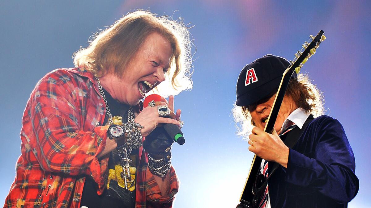 Axl Rose, left, and Angus Young perform at Olympic Stadium in London on June 4.