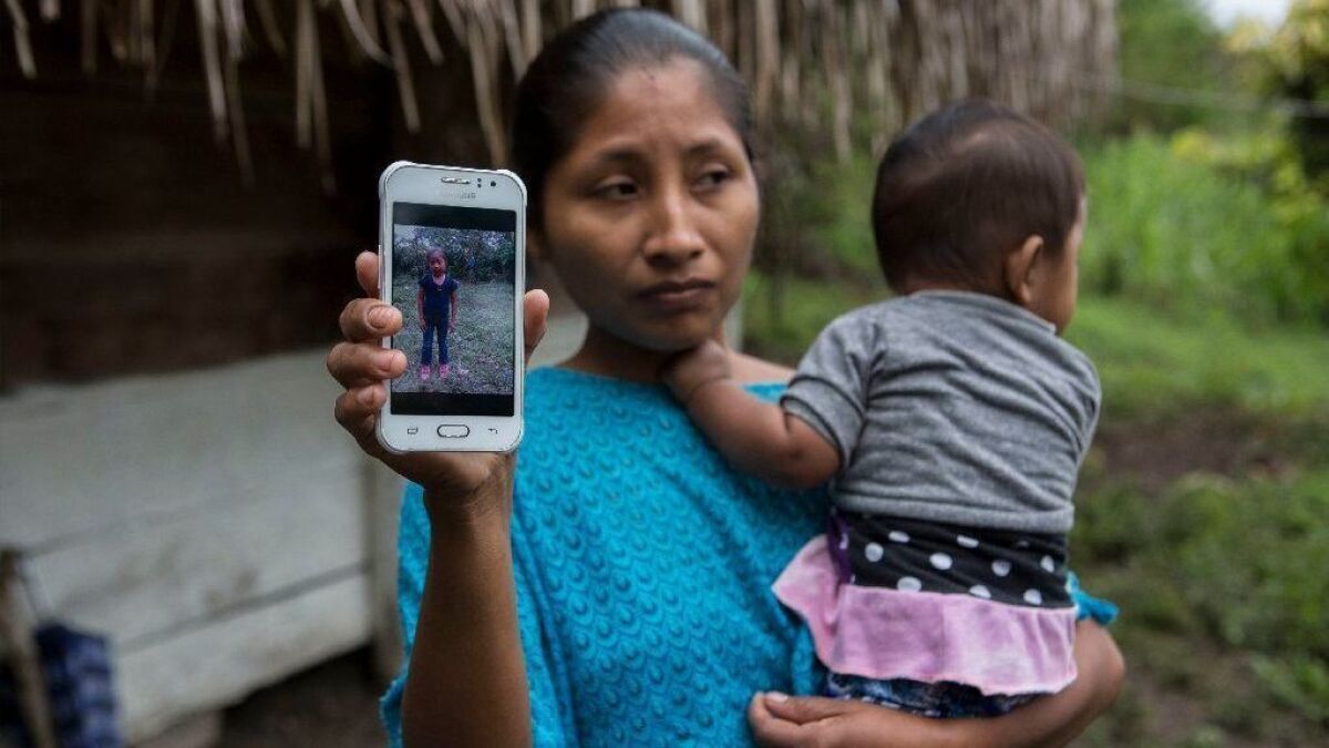 Claudia Maquin, 27, shows a photo of her daughter, Jakelin Amei Rosmery Caal Maquin, in Raxruha, Guatemala, on Dec. 15.