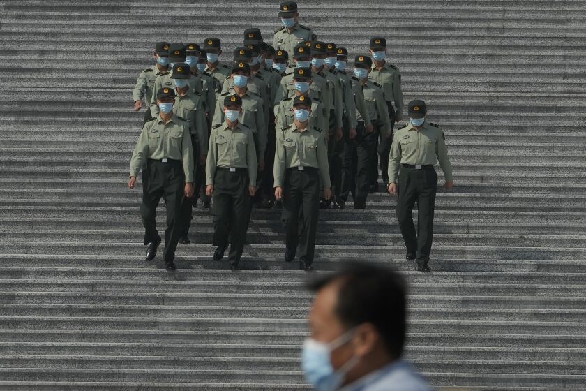 Chinese military officers march down the steps of the Great Hall of the People in Beijing, Tuesday, Sept. 27, 2022. A former top graft buster at China's ministry for intelligence and counterintelligence has been indicted on bribery charges, just weeks before a major congress of the ruling Communist Party whose leader Xi Jinping has made fighting corruption a signature issue. (AP Photo/Ng Han Guan)