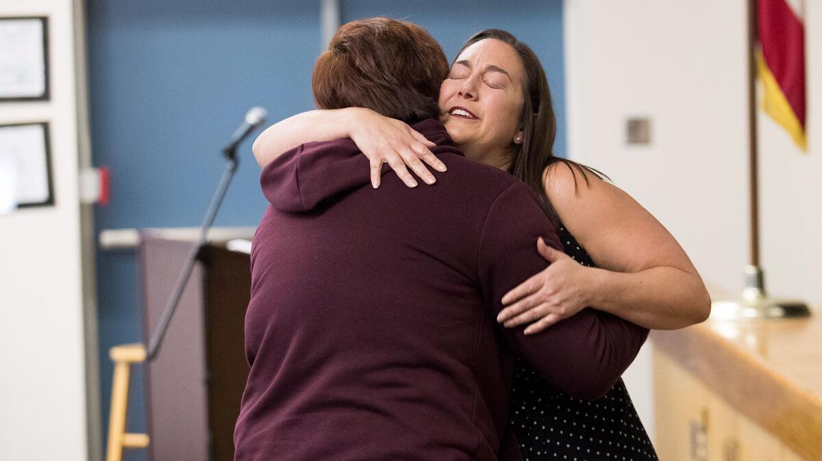 Erin Gruwell, founder of the Freedom Writers Foundation, hugs Back Bay High School senior Avery Ahuatzi, 17, during Gruwell's visit to the school Friday.