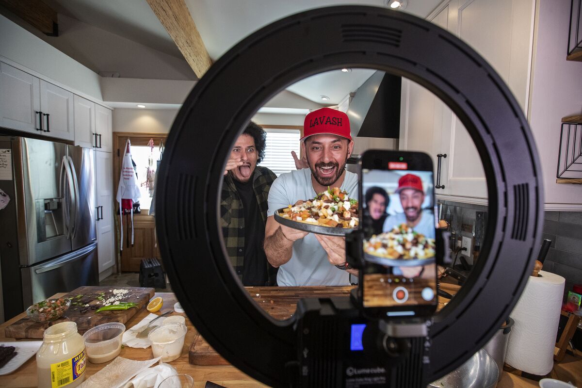 Armenian chef Ara Zada, right, shows off  french fry dish with Mexican/Armenian comedian Jack Assadourian, aka Jack Jr.