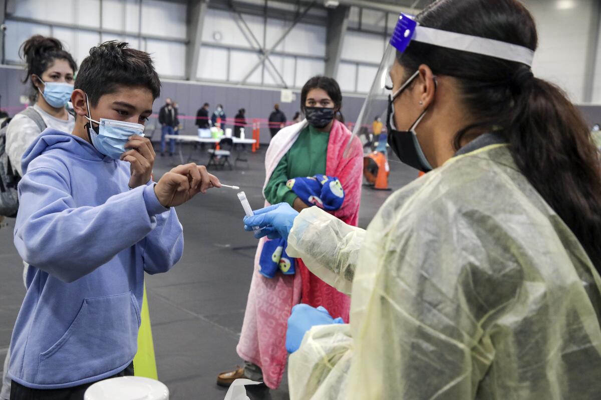 Joseph Monugian takes a nasal swab test in Rancho Cucamonga.