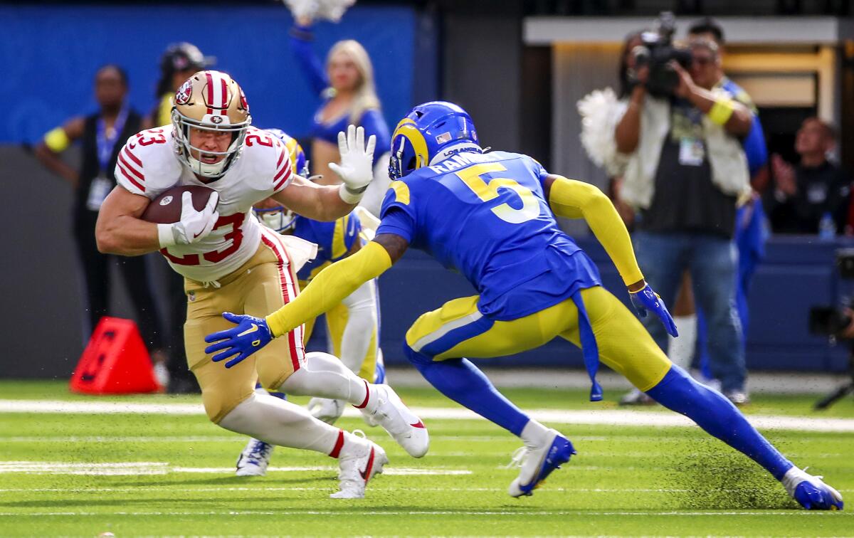 San Francisco's Christian McCaffrey runs past Rams cornerback Jalen Ramsey in the third quarter. 